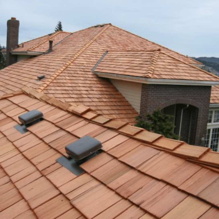 A close-up view of a clean, terracotta tile roof with visible vents and neat shingle alignment, highlighting the results of expert commercial roof cleaning services in Toledo, OH.